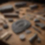 An assortment of rock engraving tools laid out on a wooden table