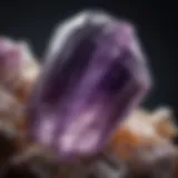 A close-up view of a raw amethyst crystal showcasing its natural facets