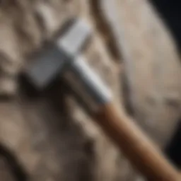 A close-up view of a rock hammer showcasing its sharp chisel and flat striking face