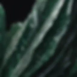 Close-up view of dark green crystal with white lines showcasing its unique texture